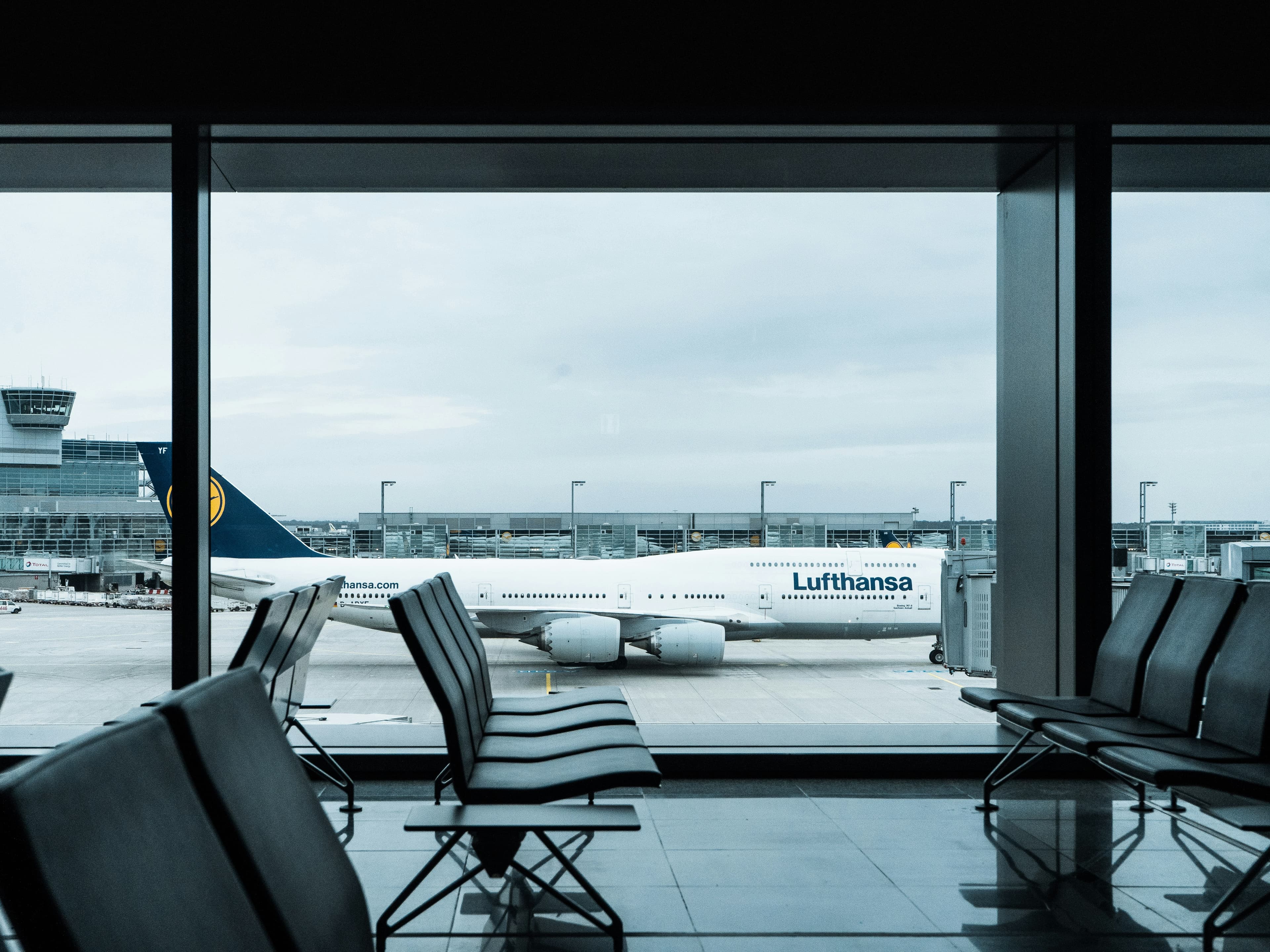 Airport departure lounge with aircraft at gate